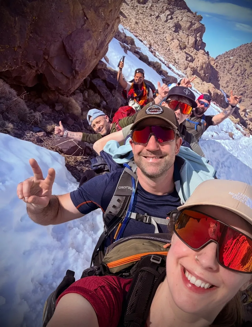 Smiling walkers together on a snowy mountain path