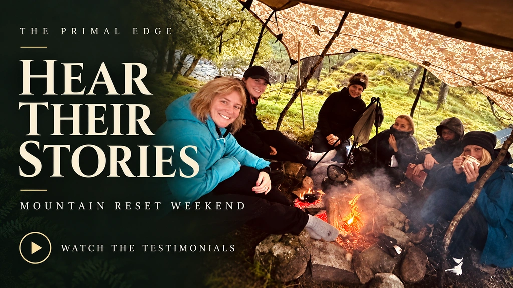 Hear their stories — Mountain Reset Weekend. Participants gathered around a campfire under a woodland shelter.