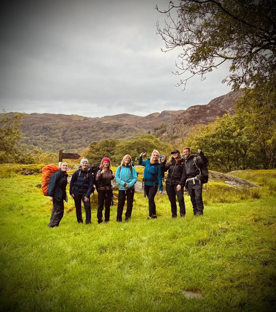 The group together in a mountain meadow