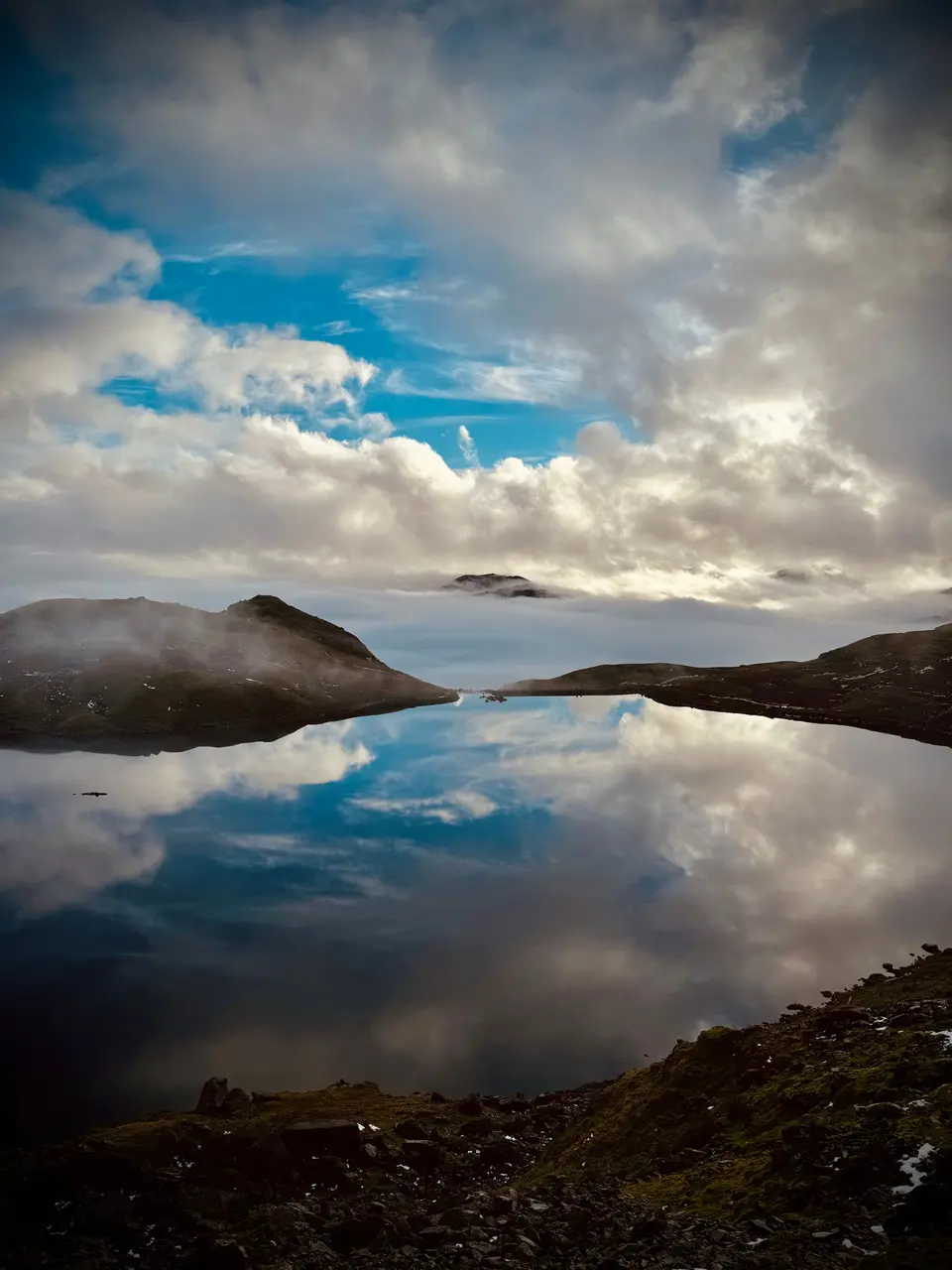 Clouds reflected in a mountain tarn
