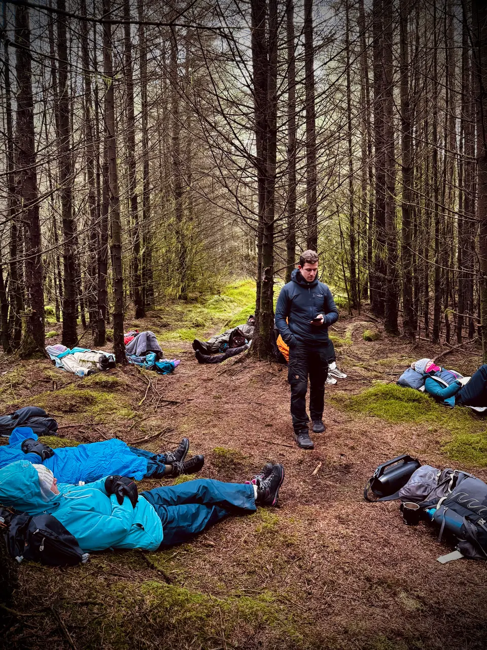 A guide with a group resting in the woods